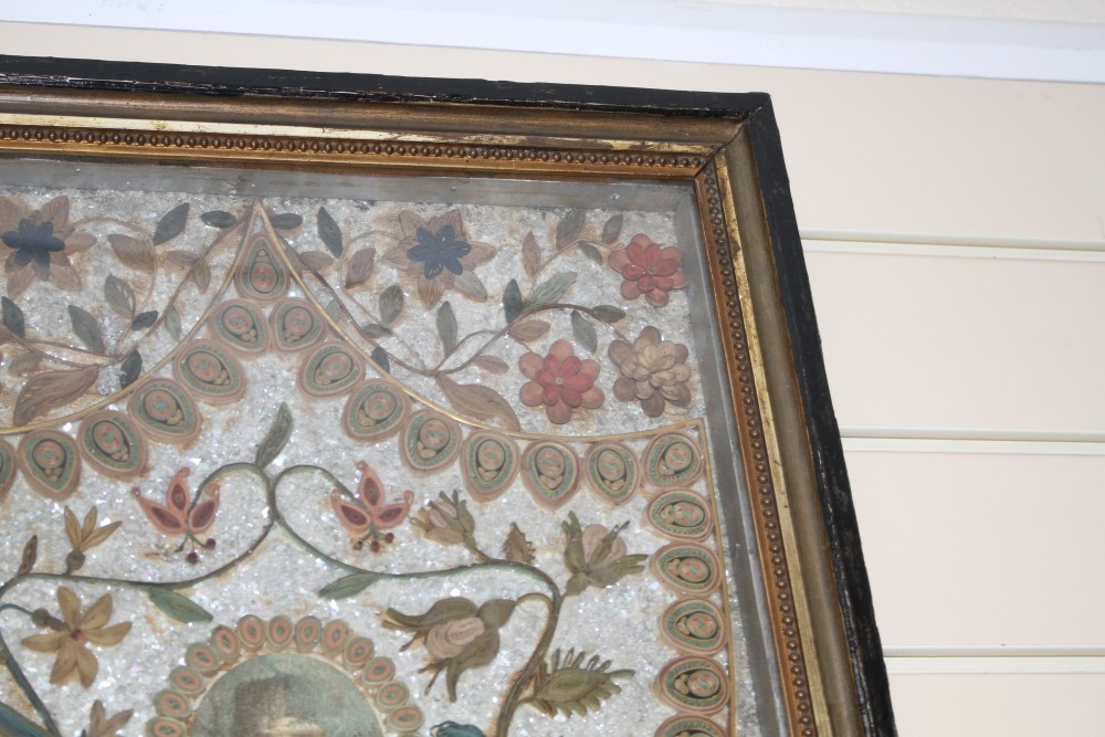 An early 19th century paper scroll work panel